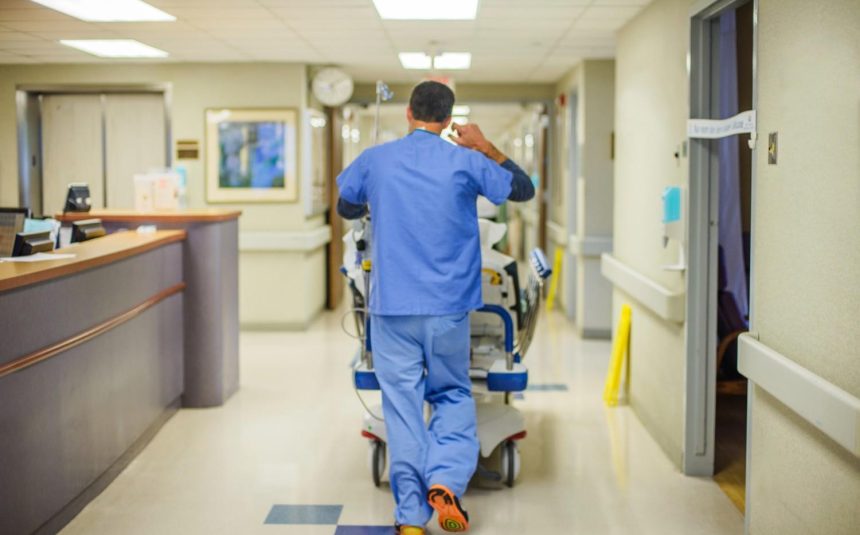 hospital-staff-walking-away-down-corridor-2026-01-09-11-14-04-utc (1)