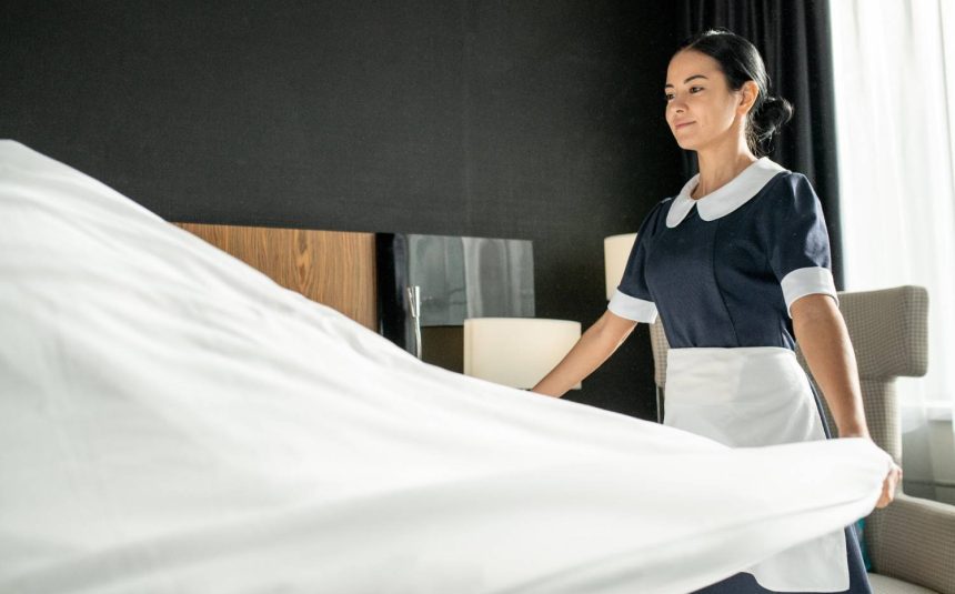 young-smiling-pretty-chambermaid-putting-white-cle-2026-01-09-06-10-43-utc (1)