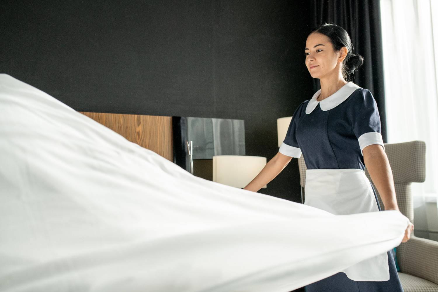young-smiling-pretty-chambermaid-putting-white-cle-2026-01-09-06-10-43-utc (1)